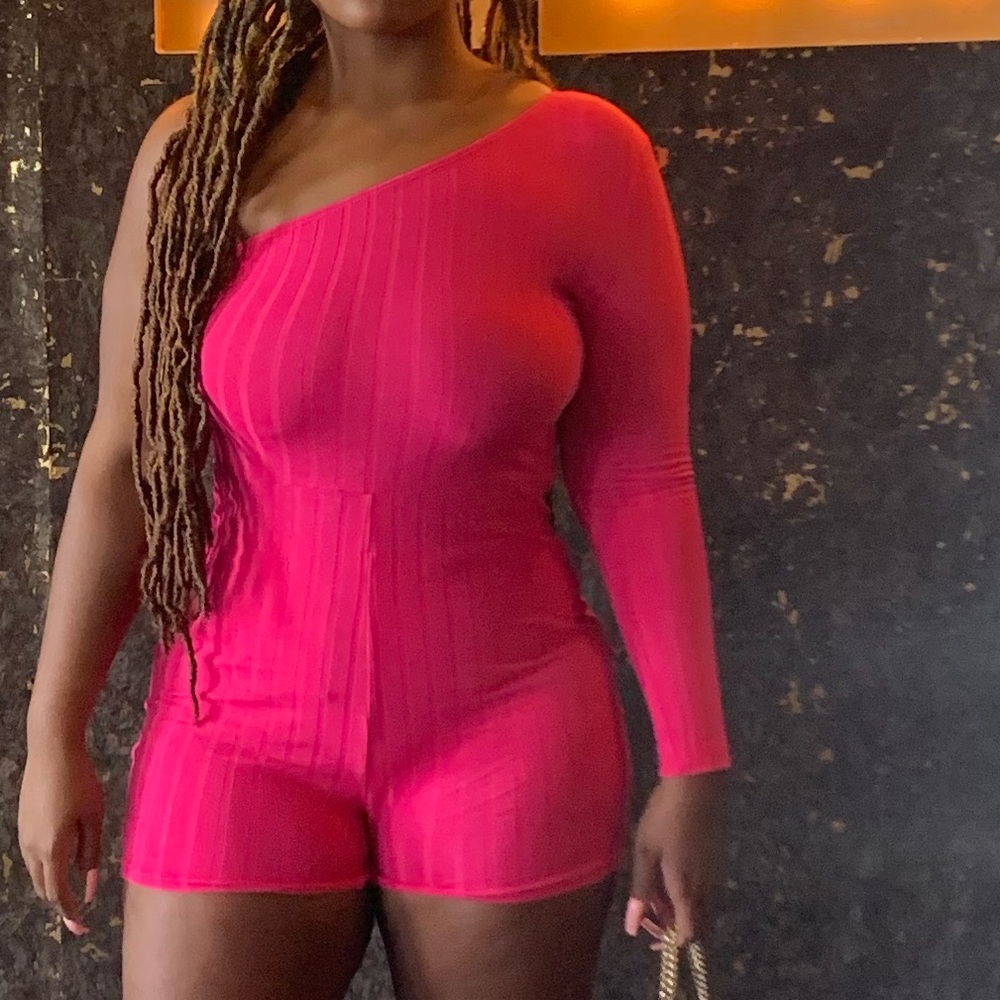 Pink one shoulder romper.